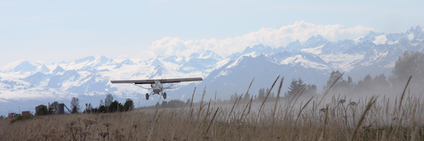 A Super Cub takes off towards snowy mountains in South-Central Alaska. Photo by David Miller.